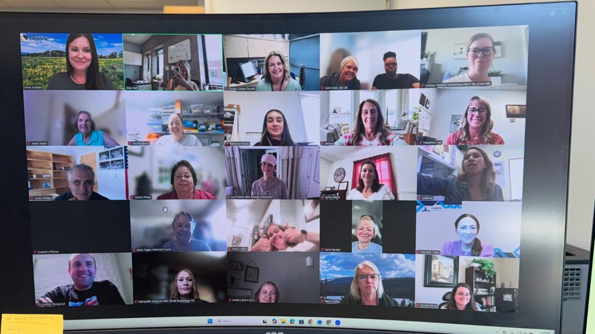 large computer monitor showing many Zoom meeting participants
