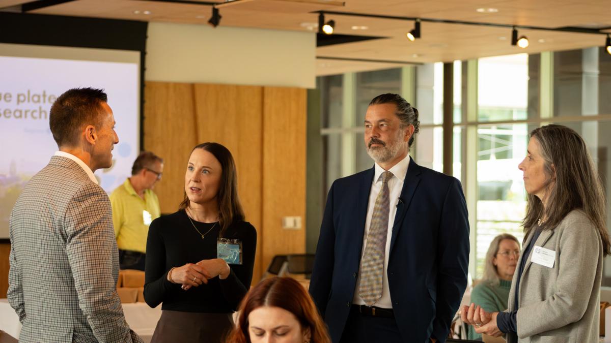 a group stands together at the Blue Plate Research event