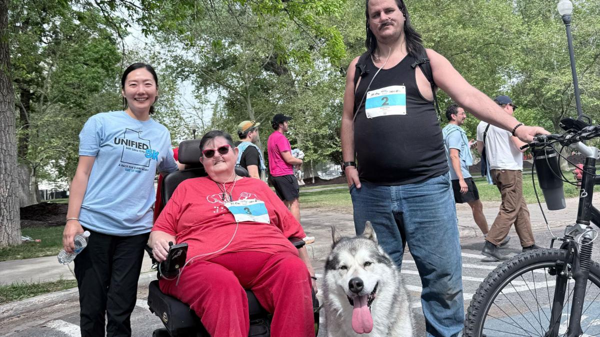 group photo in a park with a big happy service dog