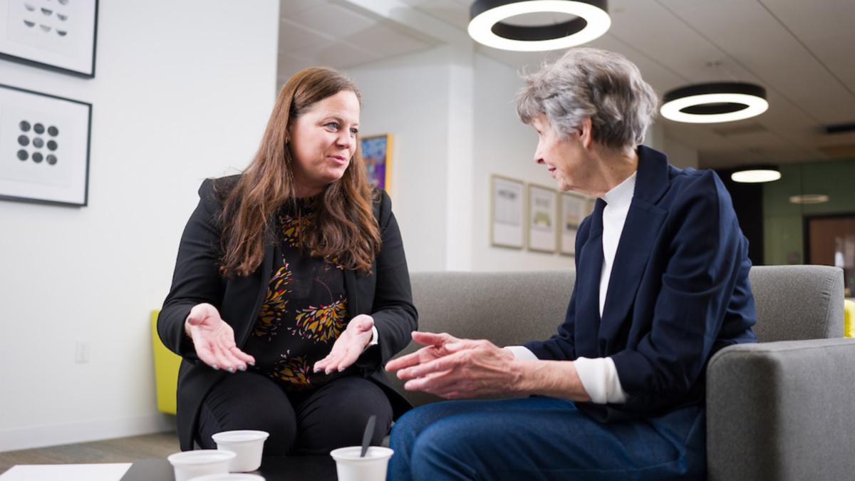 Dr. Beth Fauth speaks to an older woman who participates in a study