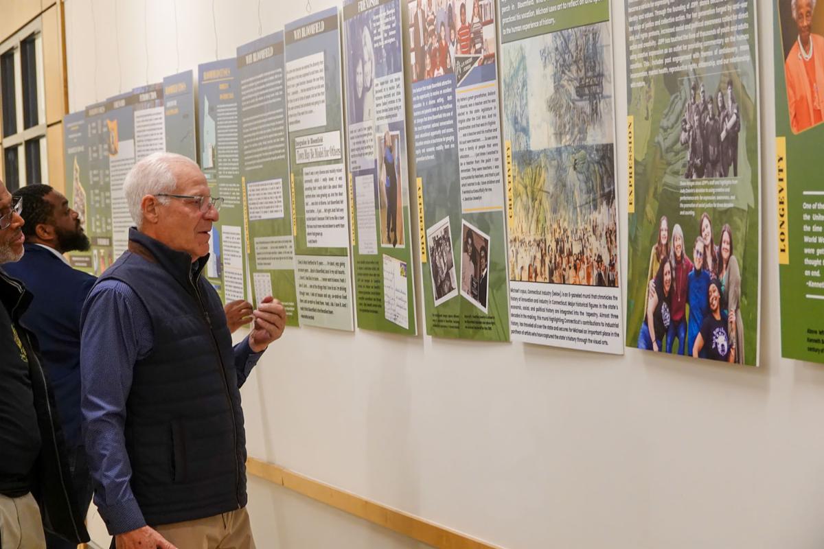 A man looking at the poster with admiration. 