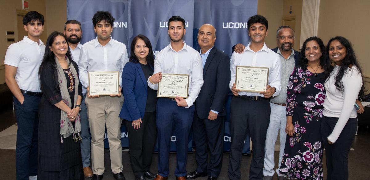 A group of Award recipients posing for a picture with their families.