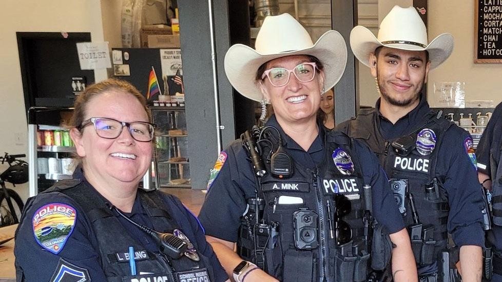 Steamboat Springs Police Officers smiling wearing cowboy hats.