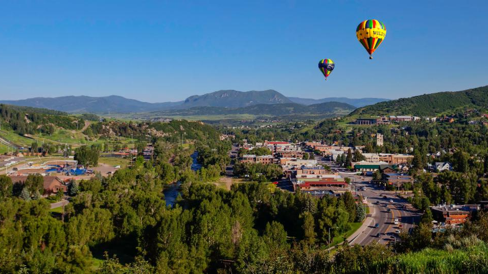 Hot air balloons flying over downtown Steamboat Springs.