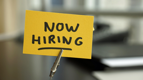 Now hiring written on a memo at the office