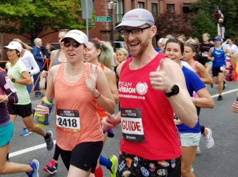 TWAV runner running with her guide in the Boston Marathon