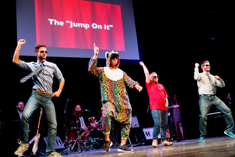 Performers dancing on stage at Extravaganza