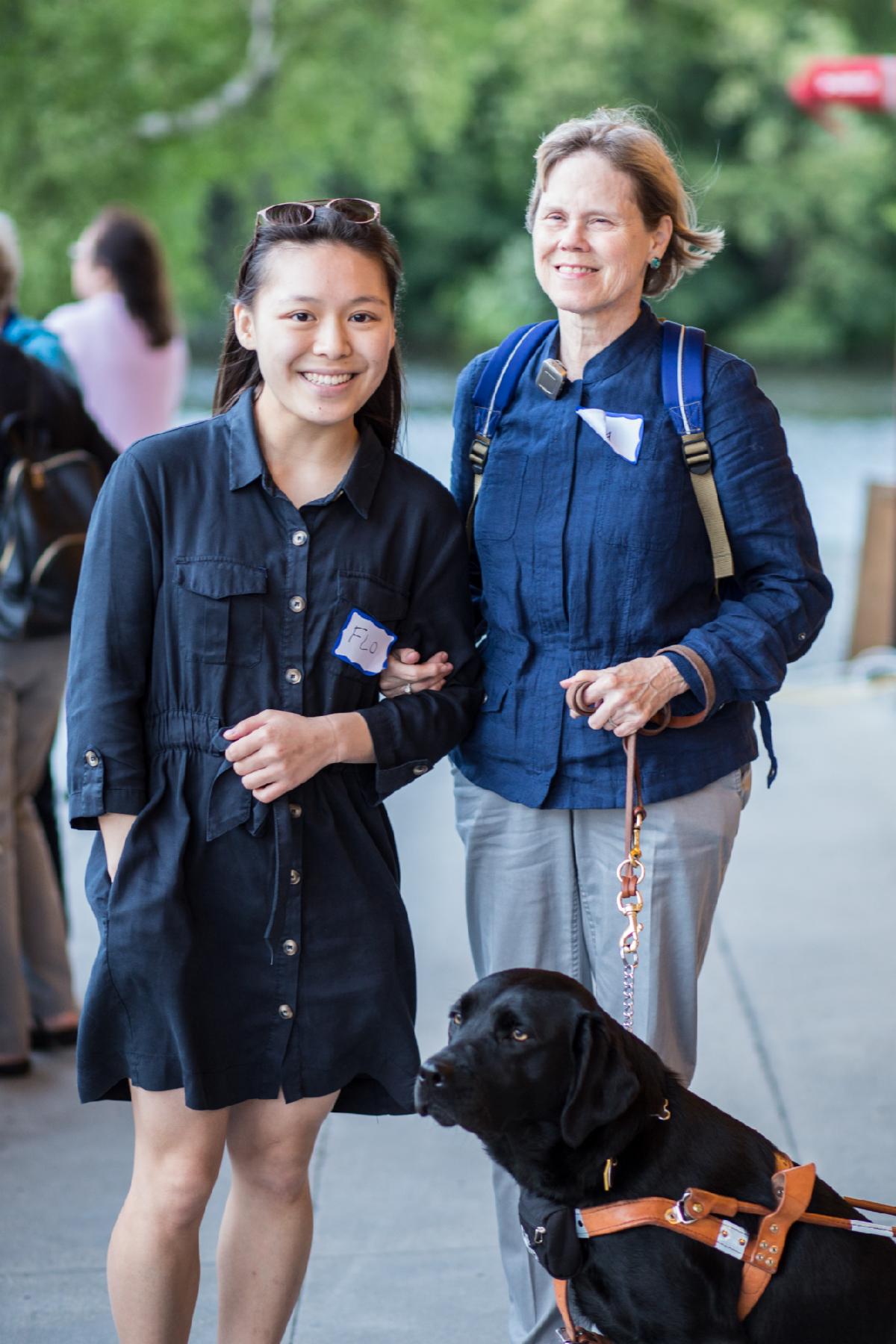 A MABVI volunteer guiding a participant who has a guide dog