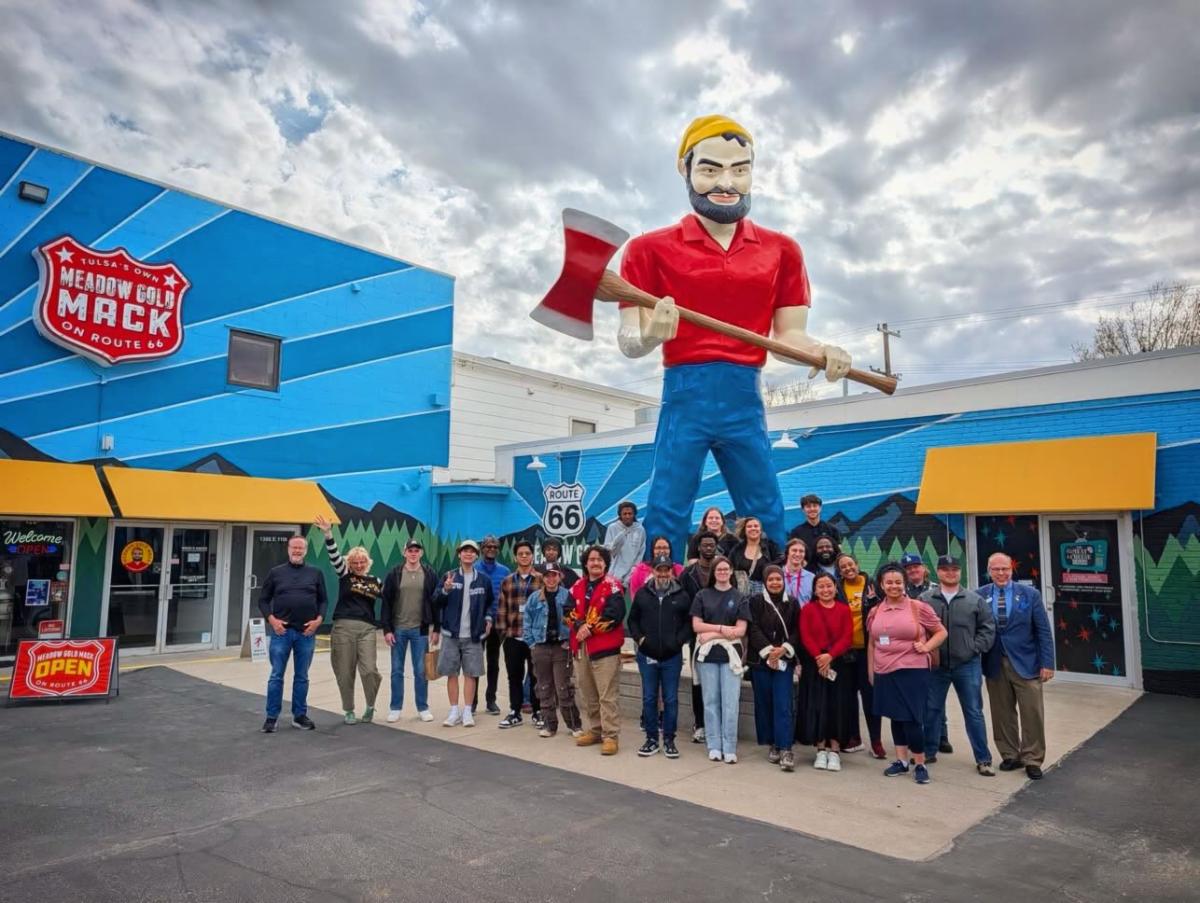 Participants in the Main Street Conference pose in front of Meadow Gold Mack's.