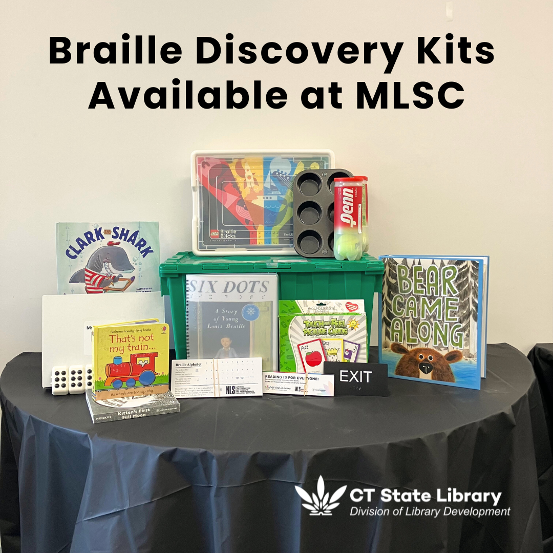 A photo of the items included in the new Braille Discovery Kits at the Middletown Library Service Center on a table with a black tablecloth against a neutral-colored wall. A description of included items can be found in the text.