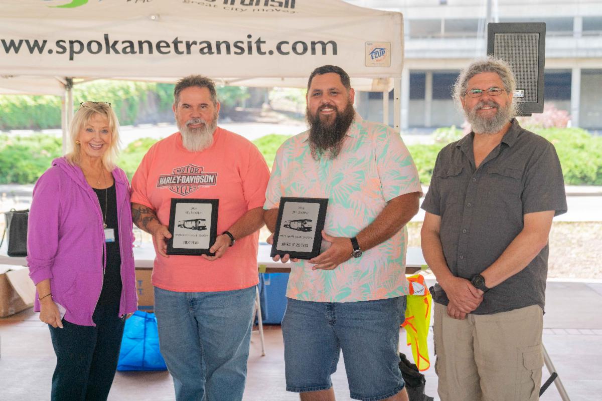 A photo of E. Susan Meyer standing with the 2024 Fixed Route Roadeo winners
