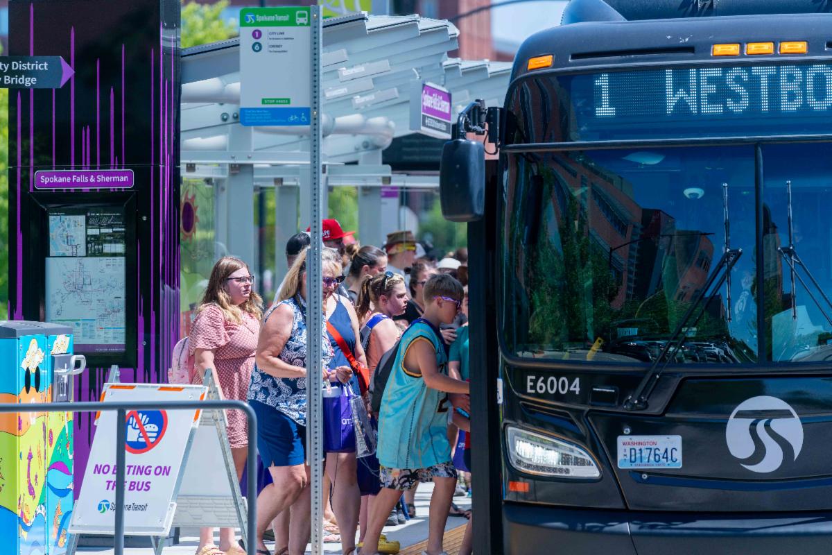 A photo of riders boarding a City Line bus on opening day, July 15, 2023
