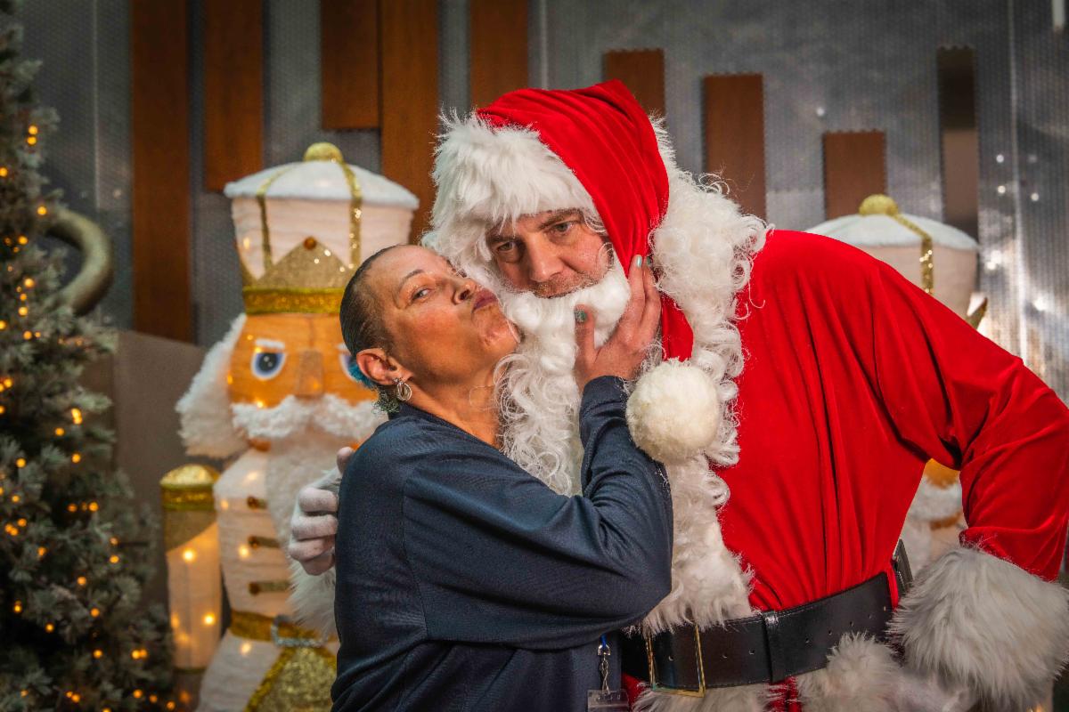 A photo of a bus driver and Santa posing