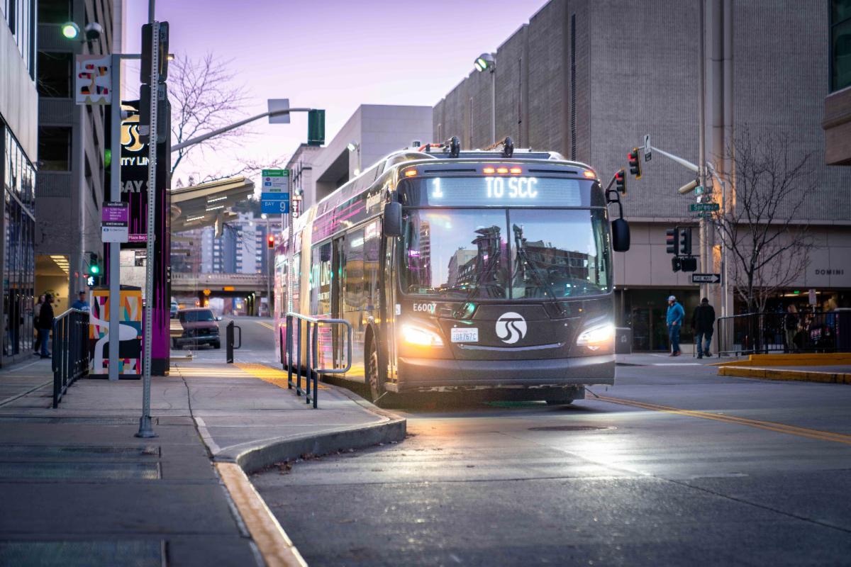 A photo of a City Line bus at the Plaza in the evening