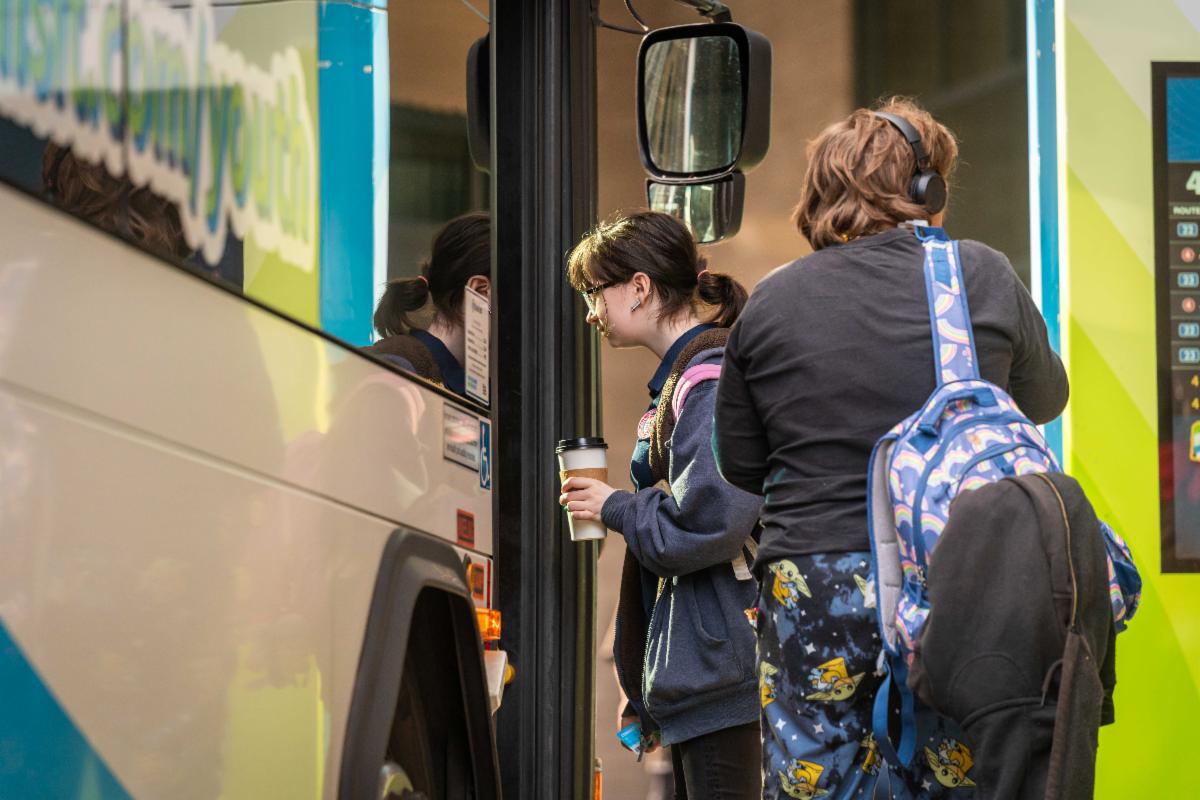 A photo of a youth boarding an STA bus at the Plaza