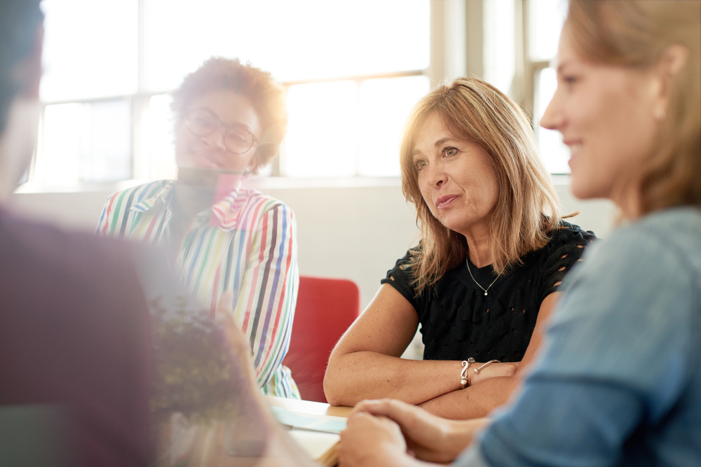 People sitting at a table in a meeting