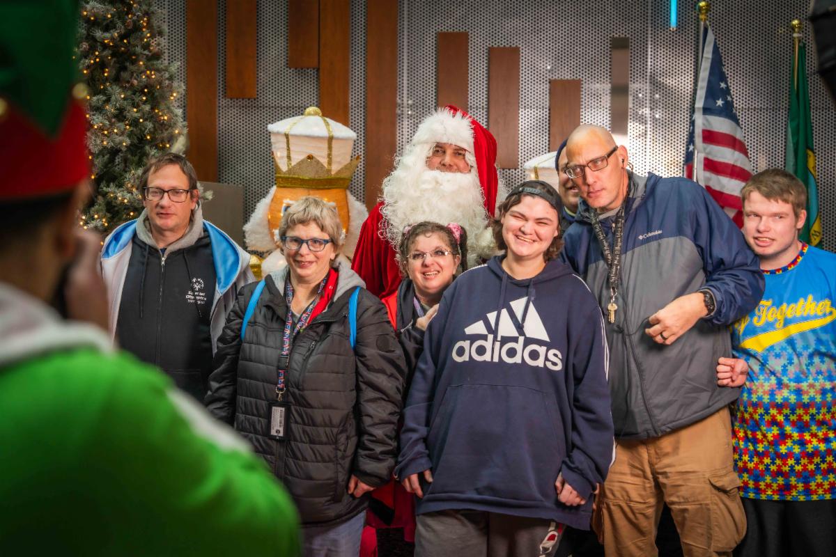 A photo of a family posing for photos with Santa