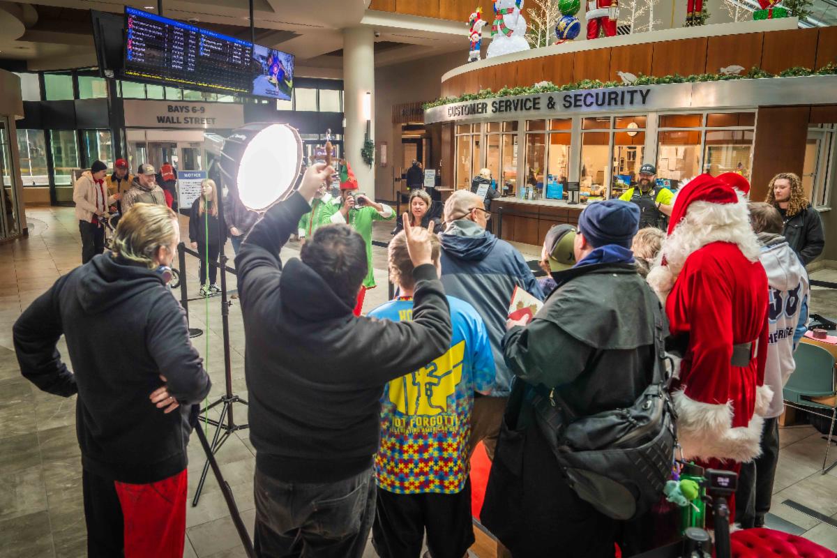 A photo of a family posing for photos with Santa