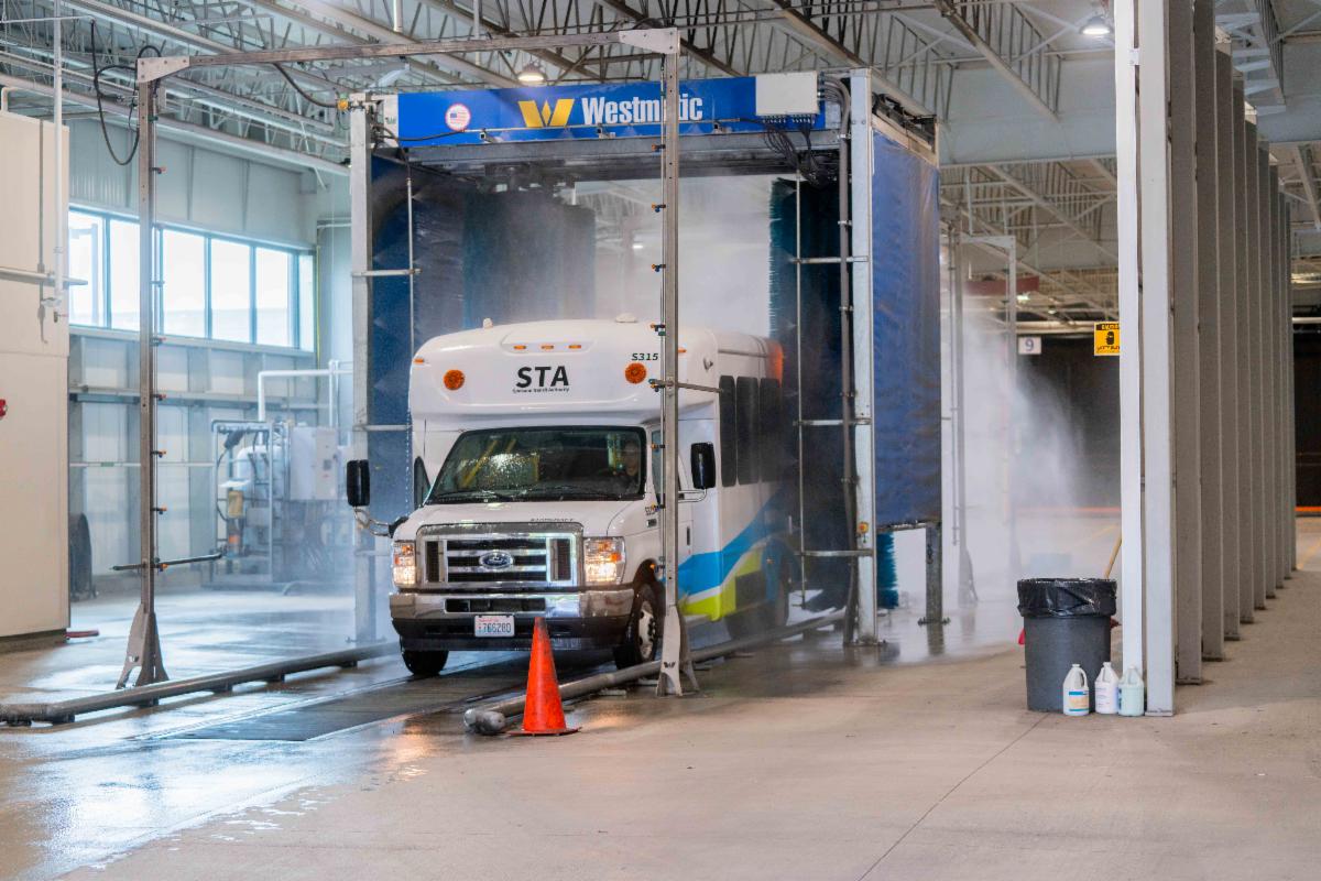 A photo of a Paratransit van in a bus washer