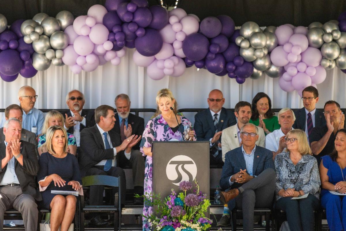 A photo of Susan giving a speech at the City Line ribbon cutting