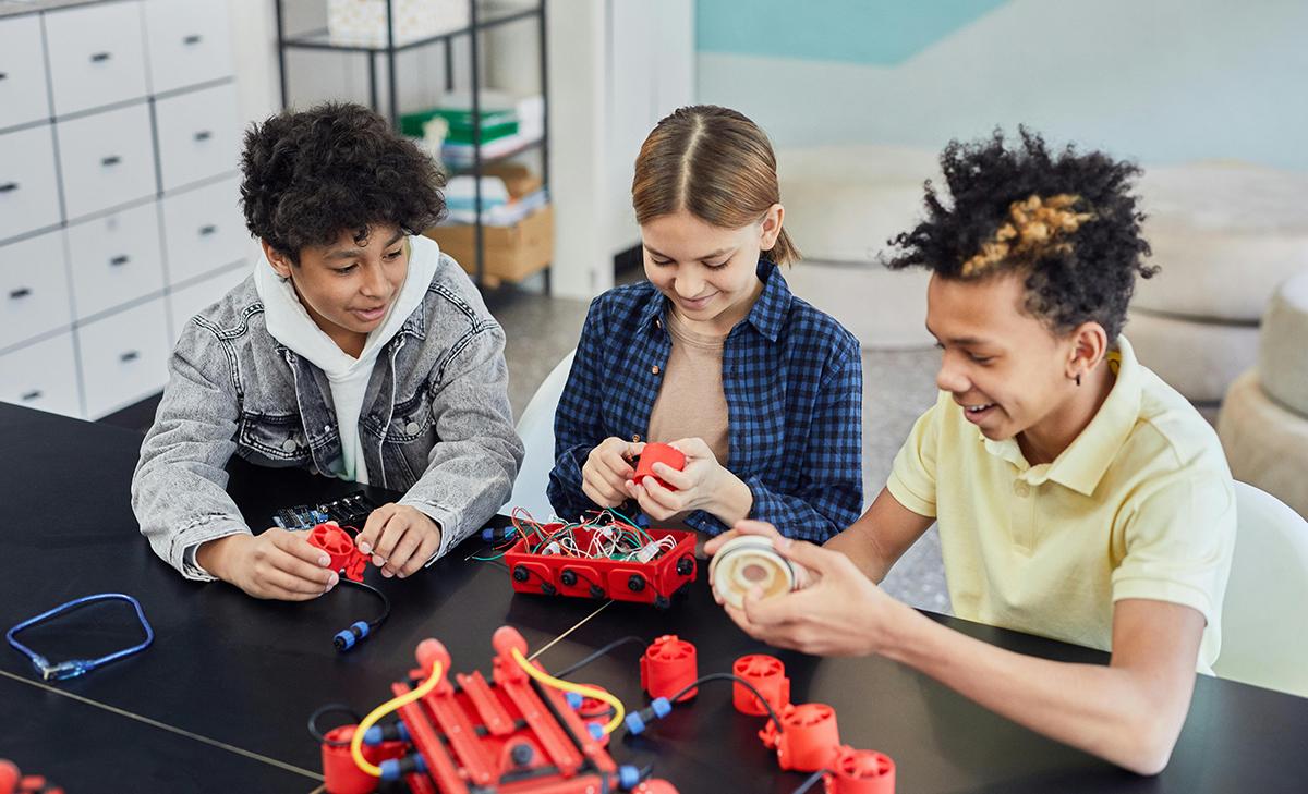 Some youth working together on a project.