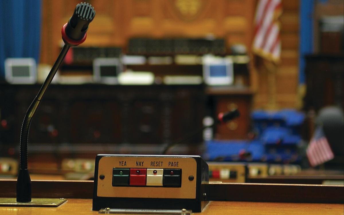 Microphone and voting station at desk in a state legislature.