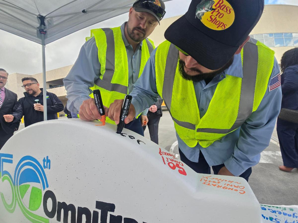 ONT staff sign the 50th Omnitrans time capsule