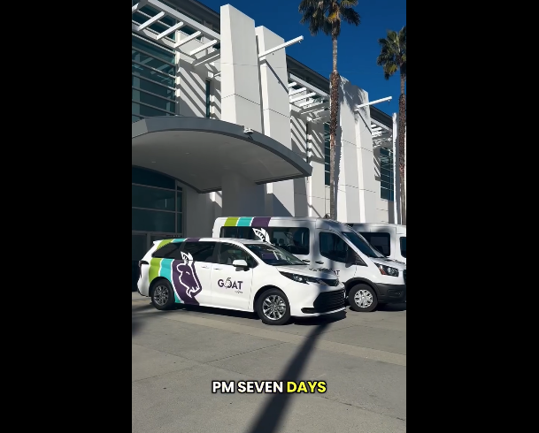 GOAT white van fleet outside of building