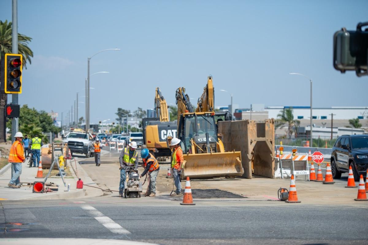 Construction crews work on street widening improvements at the intersection of Holt Avenue and Allyn Avenue in Ontario.