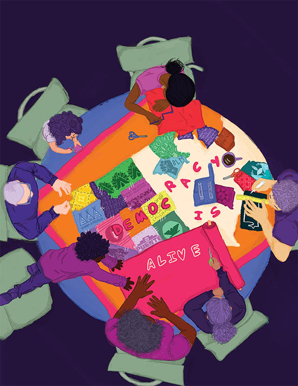 A group of people around a table repairing a quilt that says democracy is alive