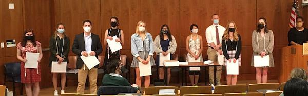 The student award winners stand in a row to receive their awards.