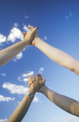 Collaborative New Director's holding hands in the sky