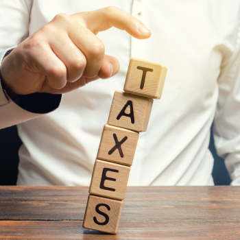 Children's blocks that spell "taxes"