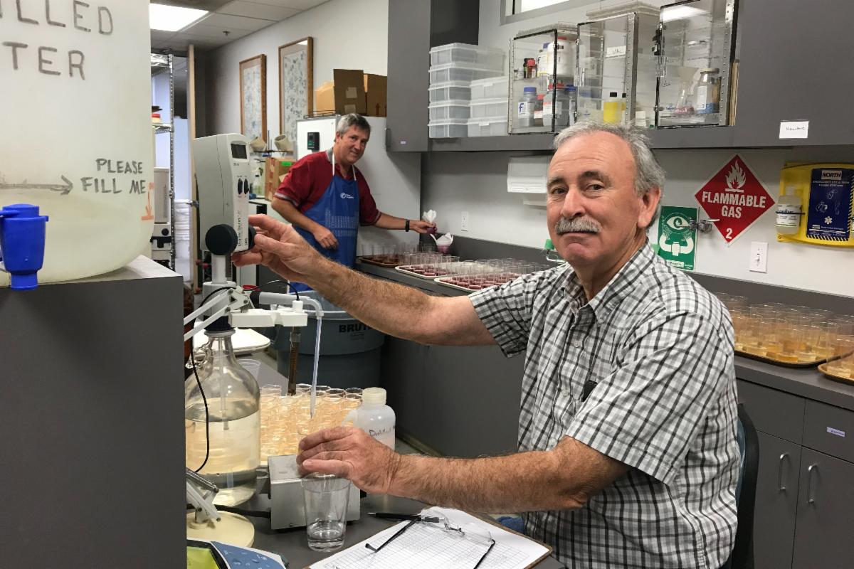Larry Bettiga, right, works in a lab with technician Evan Oaks in the background