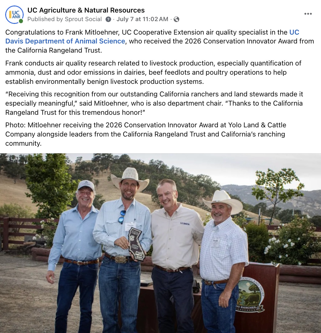 Frank Mitloehner, wearing a UC Davis shirt, flanked by ranchers as he receives a conservation award