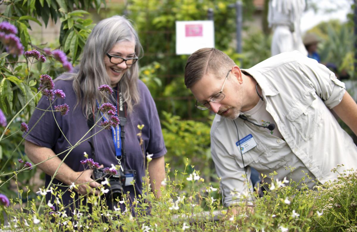 Randy Musser, UC Master Gardener Coordinator (right), and a Master Gardener volunteer inspect plants at South Coast Research and Extension Center