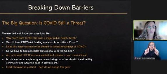 Zoom conference screen shot with presenter and ASL interpreter pictured on the right hand side and a presentation slide pictured on the left that reads Breaking down barriers, Is COVID 19 still a threat?