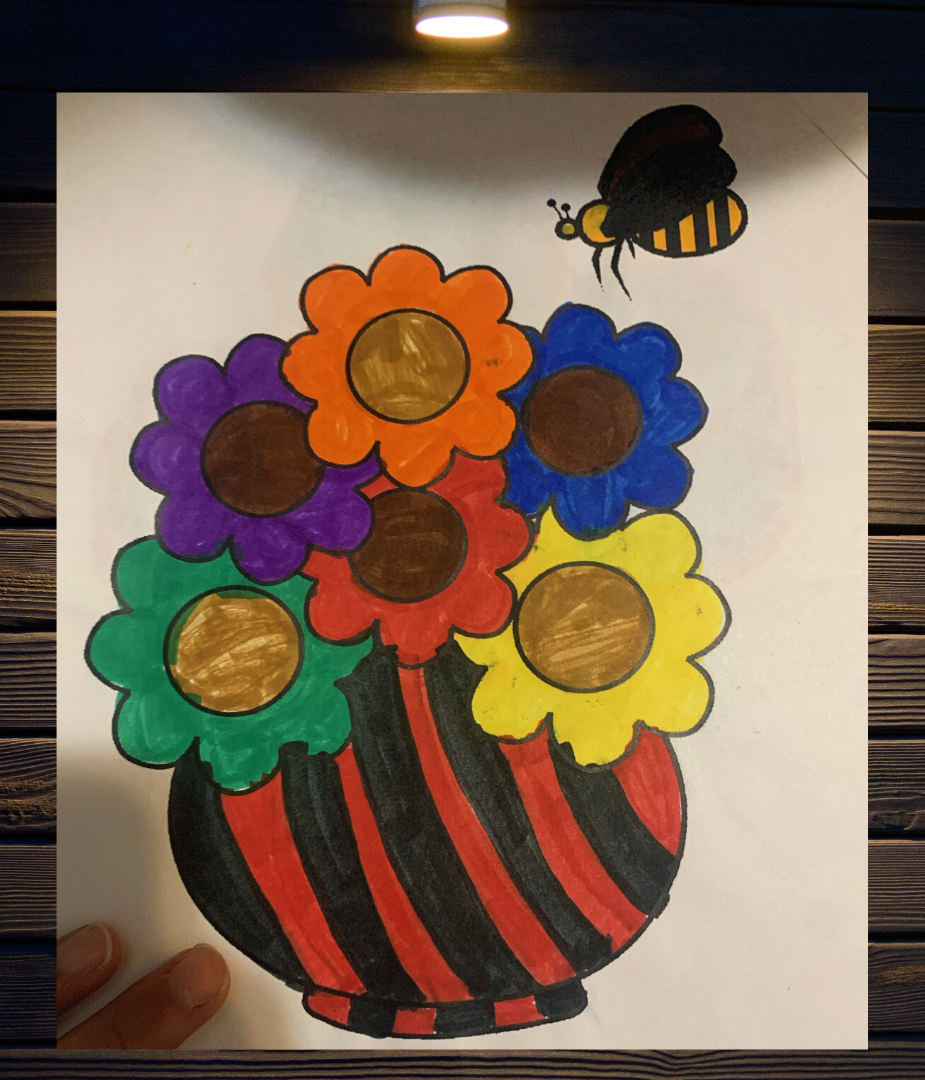 original coloring page of a flower pot with bright colored flowers and bee buzzing over