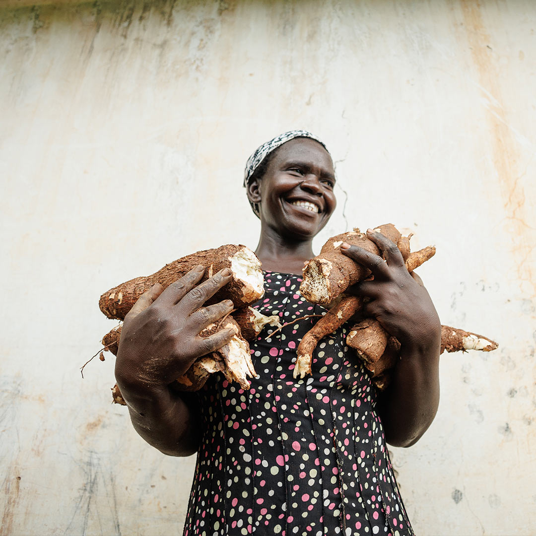 Woman holding cassava.