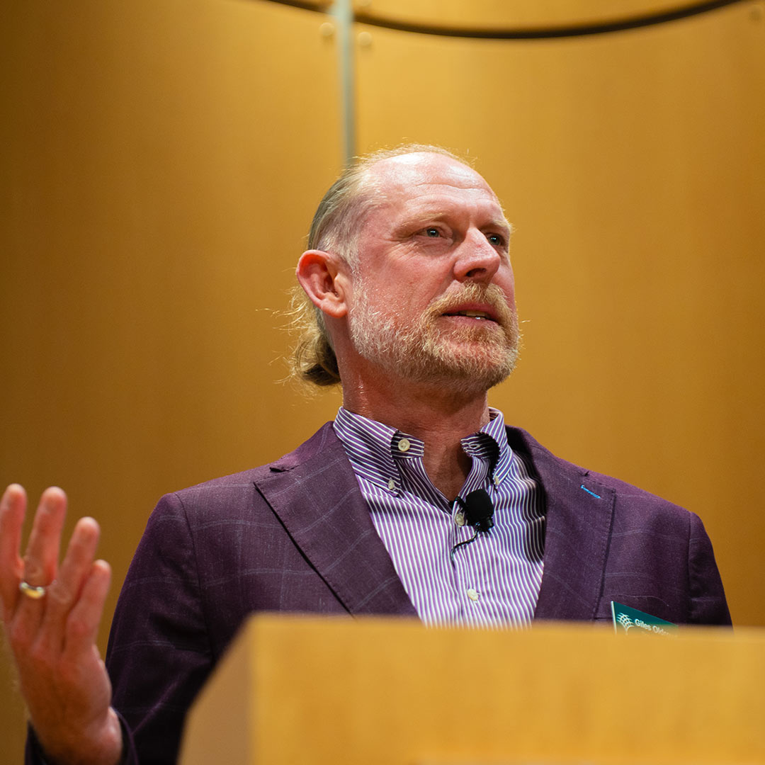 Giles Oldroyd at a podium.