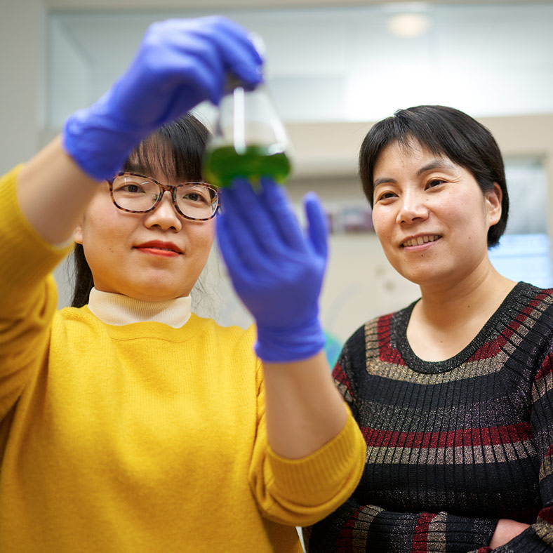 Ru Zhang with a lab member.