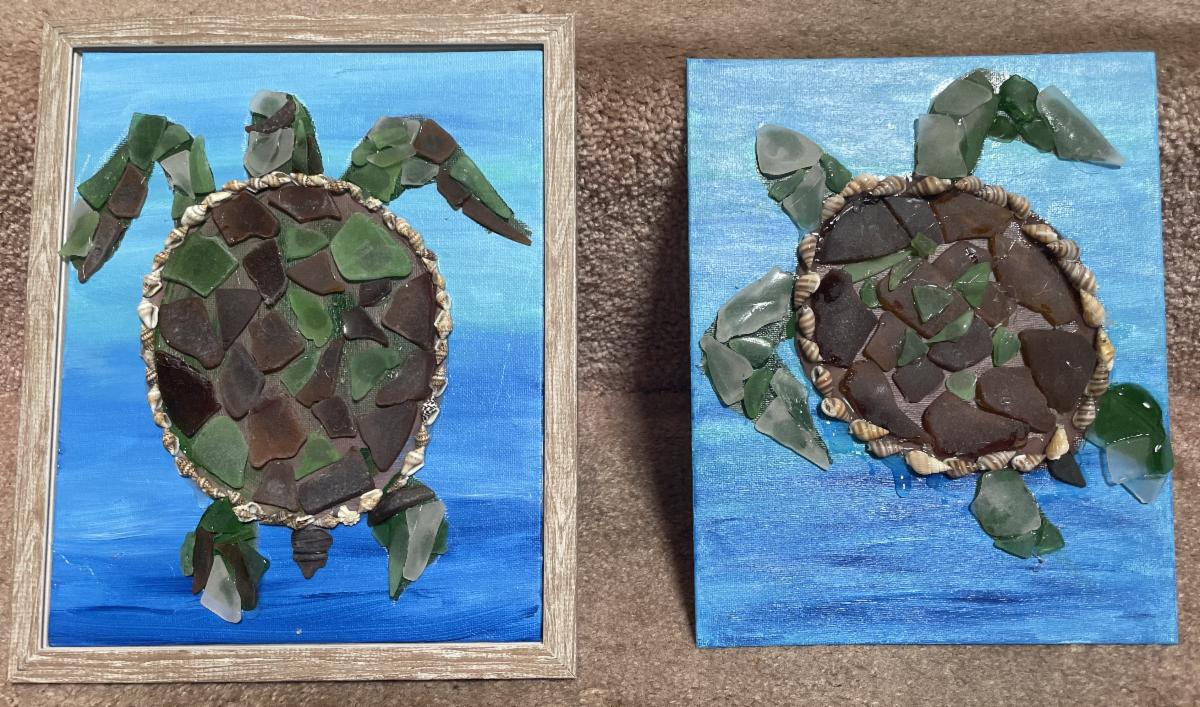 Two framed sea turtles made from sea glass and shells.