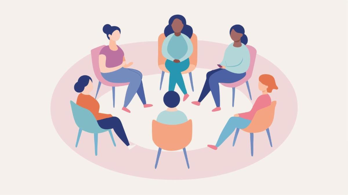 A group of people sitting in chairs in a circle.