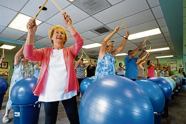 Older adults Exercising with Yoga Balls and Drumsticks