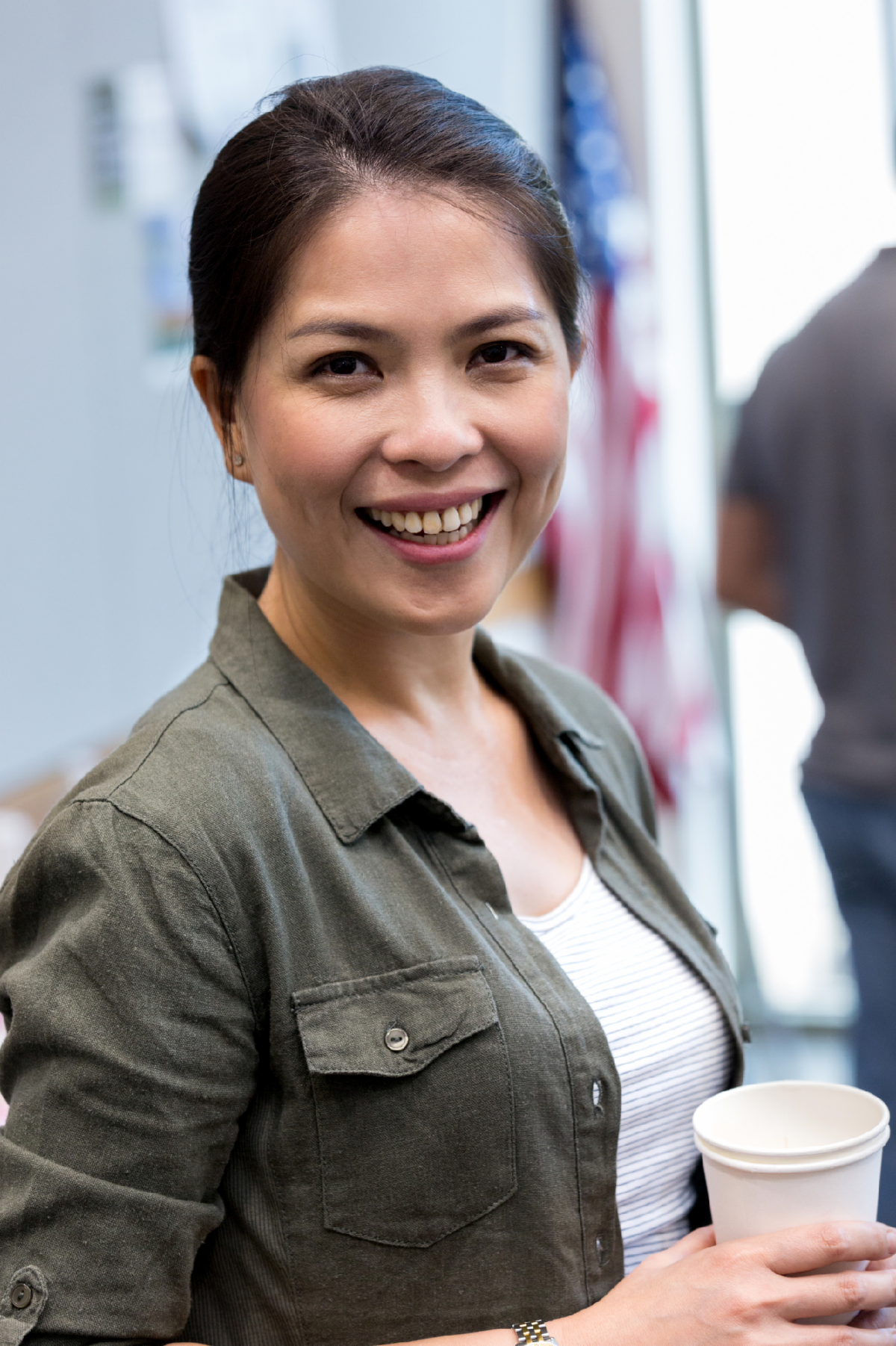 A female veteran holding a coffee cup.