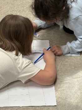 Students creating soccer themed board game