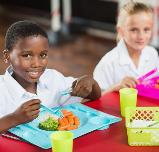 children eating food at a table