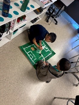 Students creating soccer themed board game