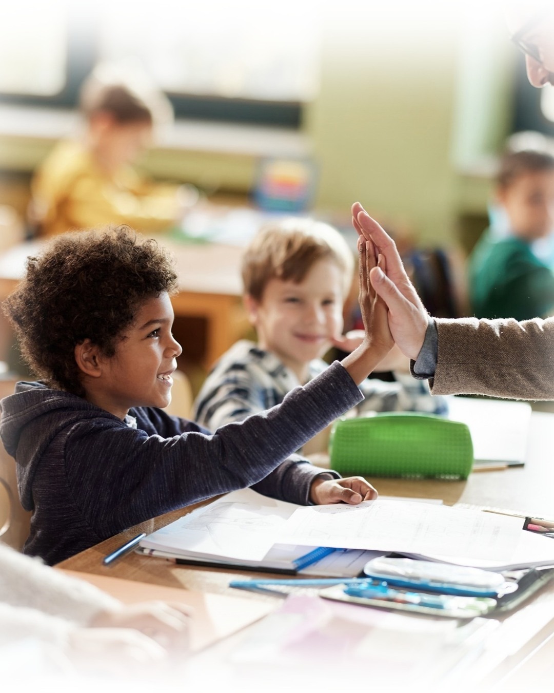 Student high-fiving teacher