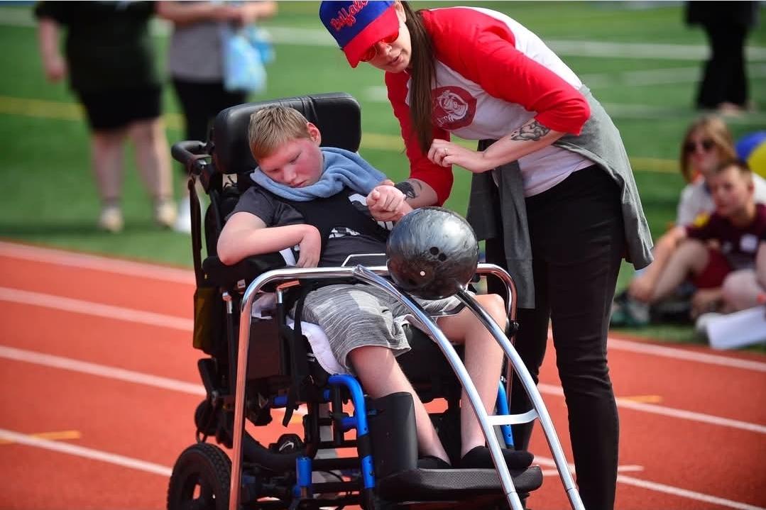 New York State School for the Blind Special Olympics, student in wheelchair going down track